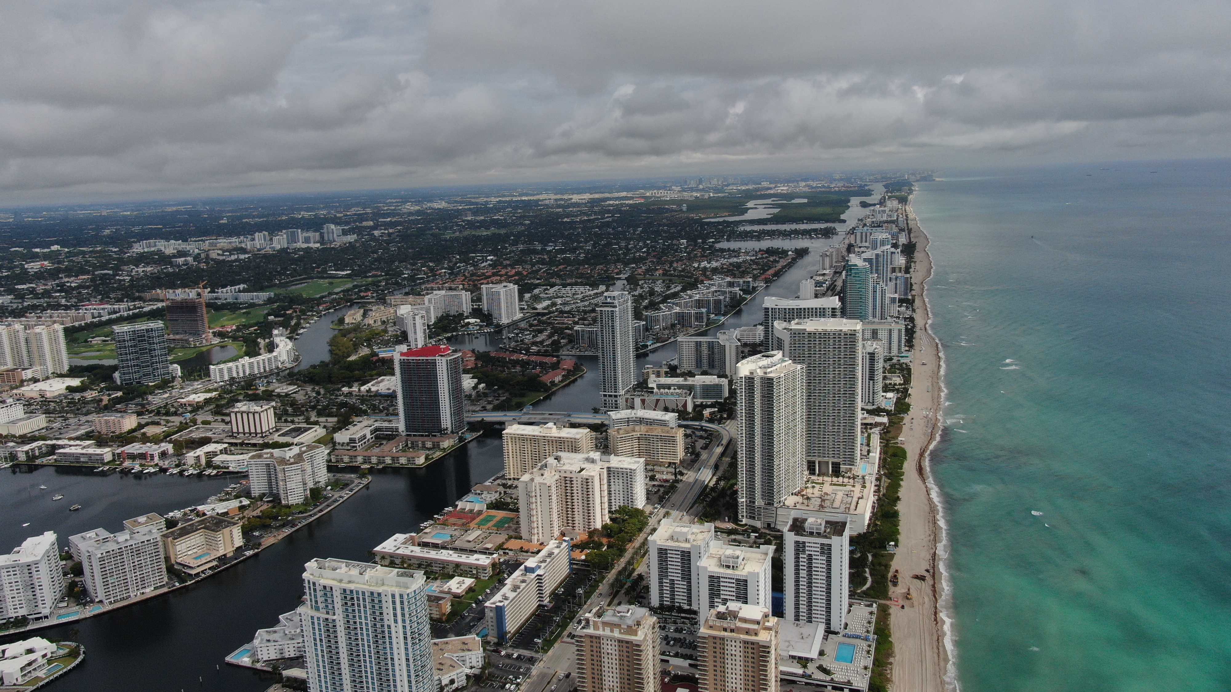 Aerial view of South Florida coastline, high-rise buildings, waterways, and the Atlantic Ocean